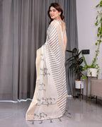 Off-White Handloom Linen Saree with Black Vertical Stripes & Tribal Motifs | Golden Zari Border & Tassel Pallu | Attached Blouse | 5.5m Saree + 0.8m Blouse