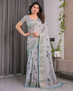 Elegant Ice Grey Handloom Linen Saree with Floral Print, Gold Zari Border & Tassel Detailing | Attached Blouse Piece | 5.5m Saree + 0.8m Blouse