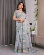 Elegant Ice Grey Handloom Linen Saree with Floral Print, Gold Zari Border & Tassel Detailing | Attached Blouse Piece | 5.5m Saree + 0.8m Blouse